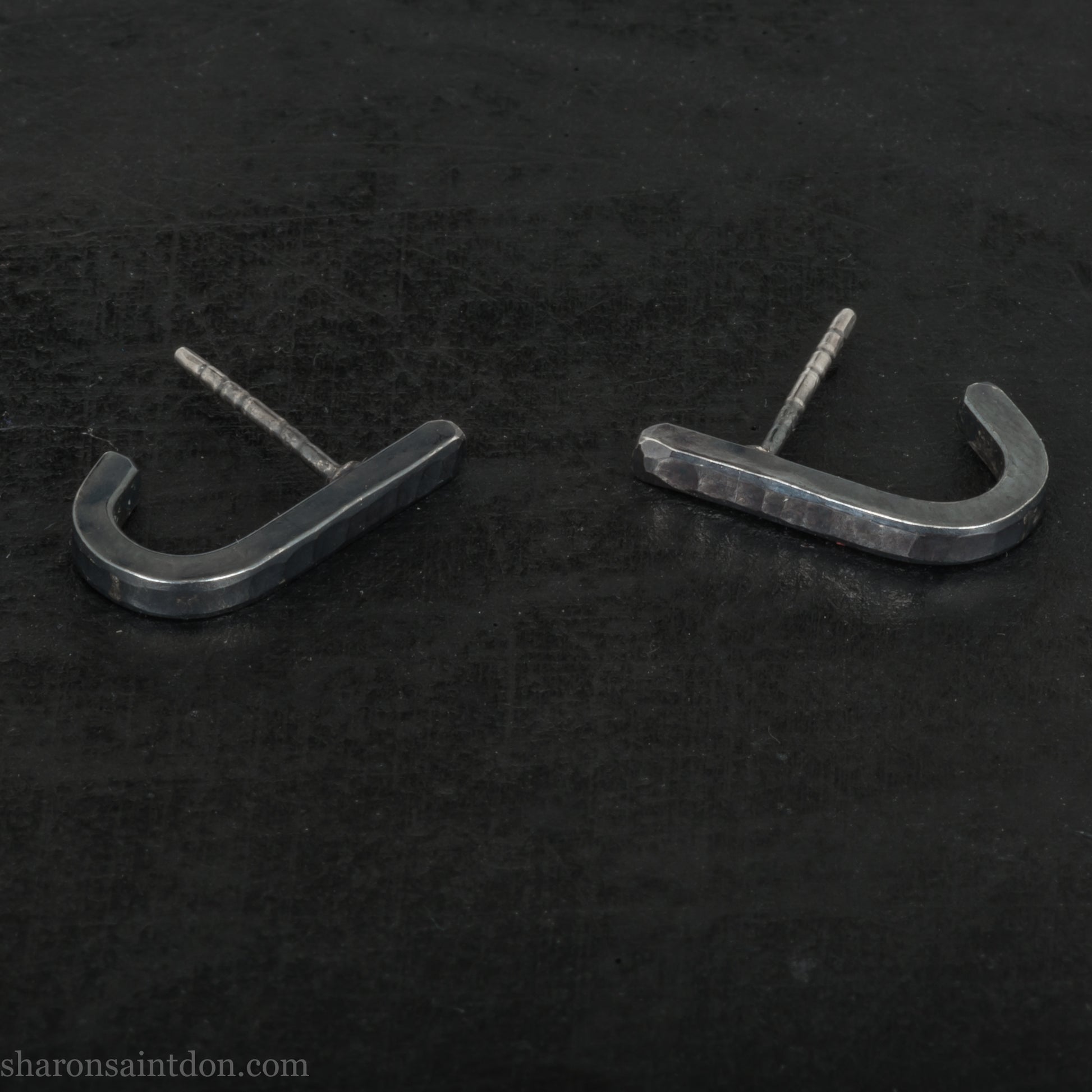 Hand hammered oxidized black sterling silver J-Curve hoop earrings, oxidized black patina.