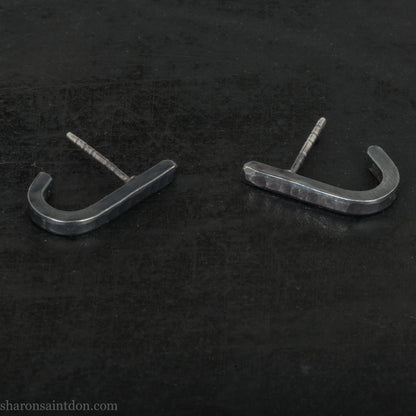 Hand hammered oxidized black sterling silver J-Curve hoop earrings, oxidized black patina.