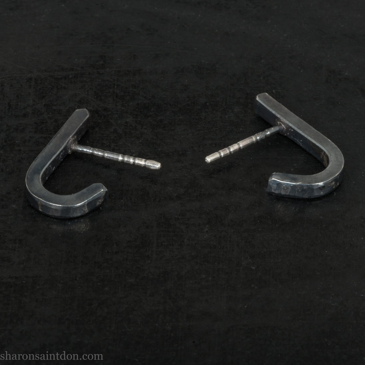 Hand hammered oxidized black sterling silver J-Curve hoop earrings, oxidized black patina.