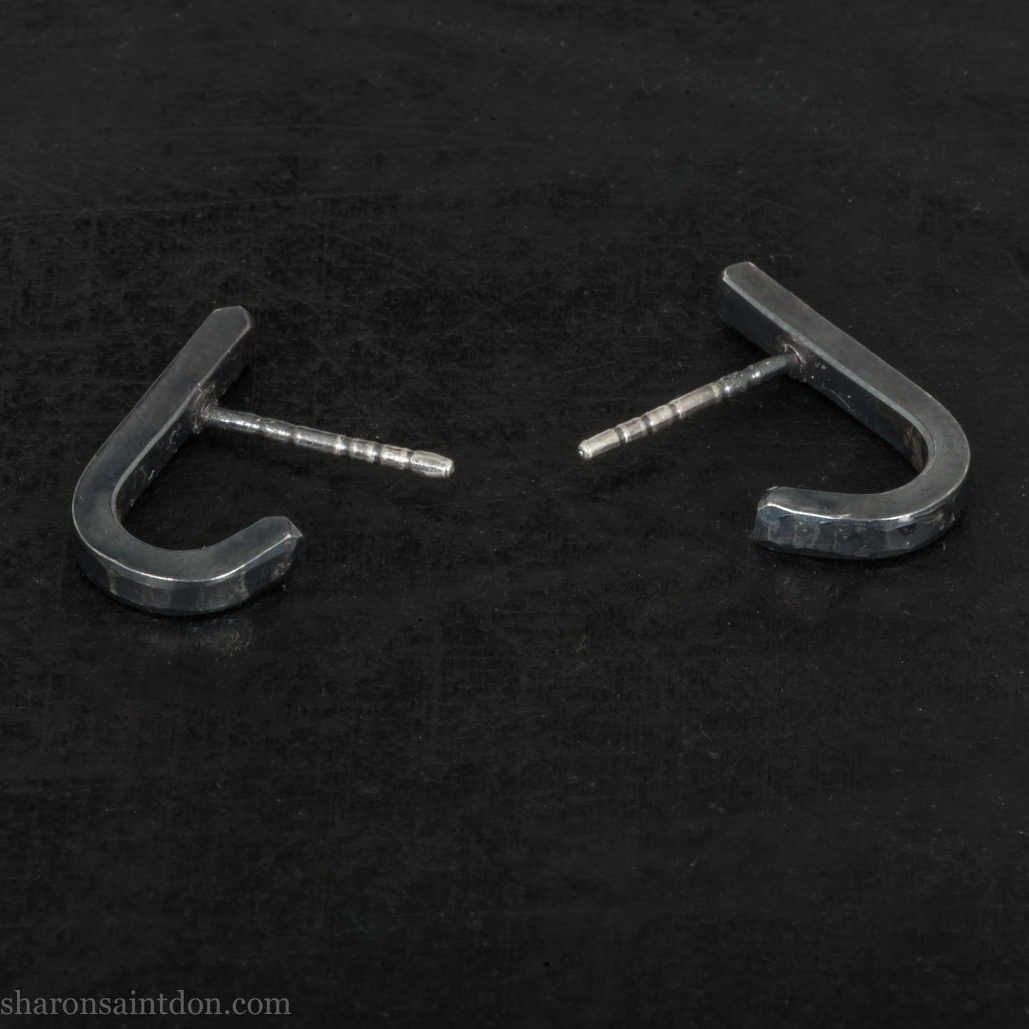 Hand hammered oxidized black sterling silver J-Curve hoop earrings, oxidized black patina.