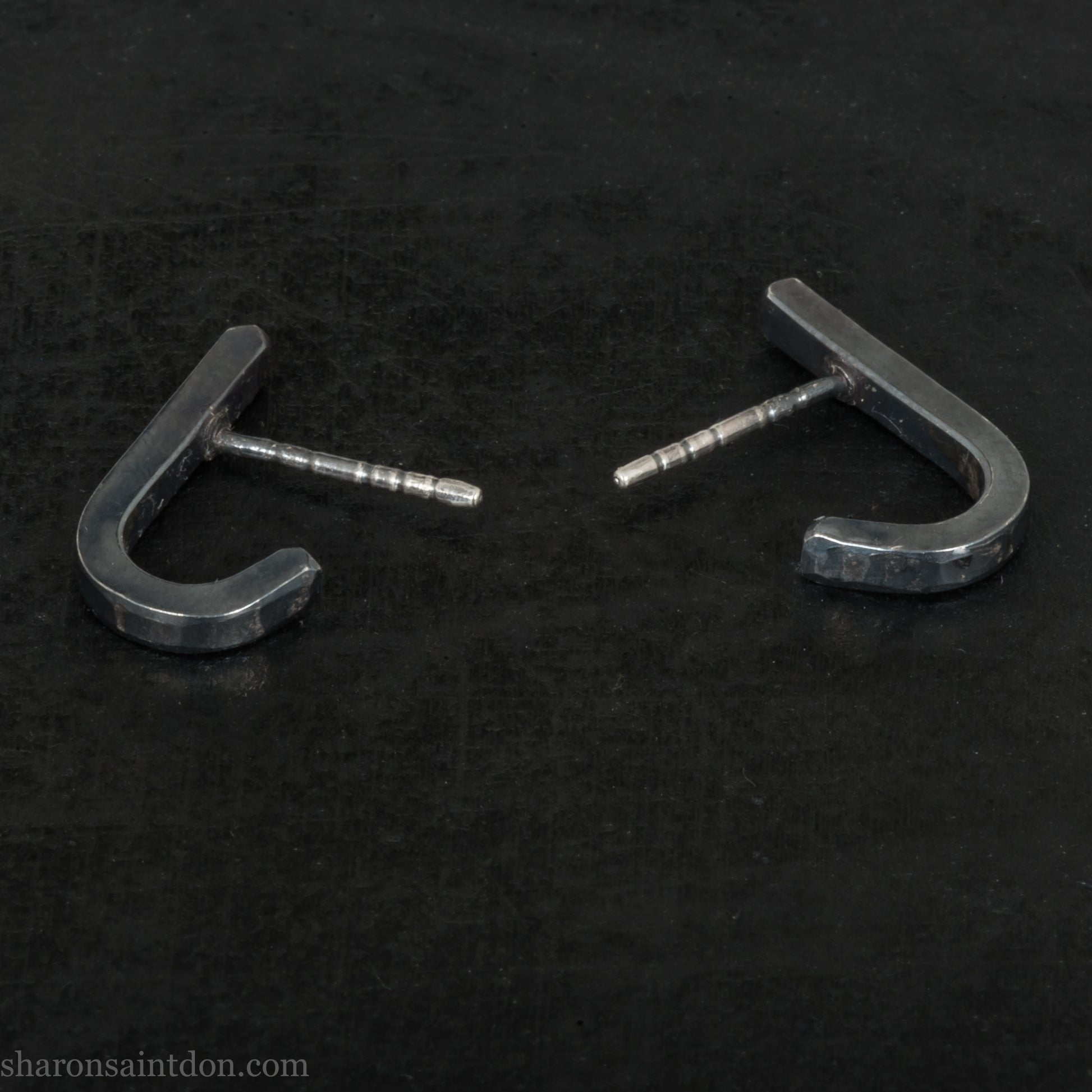 Hand hammered oxidized black sterling silver J-Curve hoop earrings, oxidized black patina.