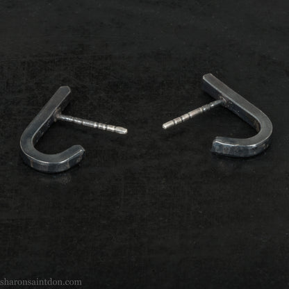 Hand hammered oxidized black sterling silver J-Curve hoop earrings, oxidized black patina.