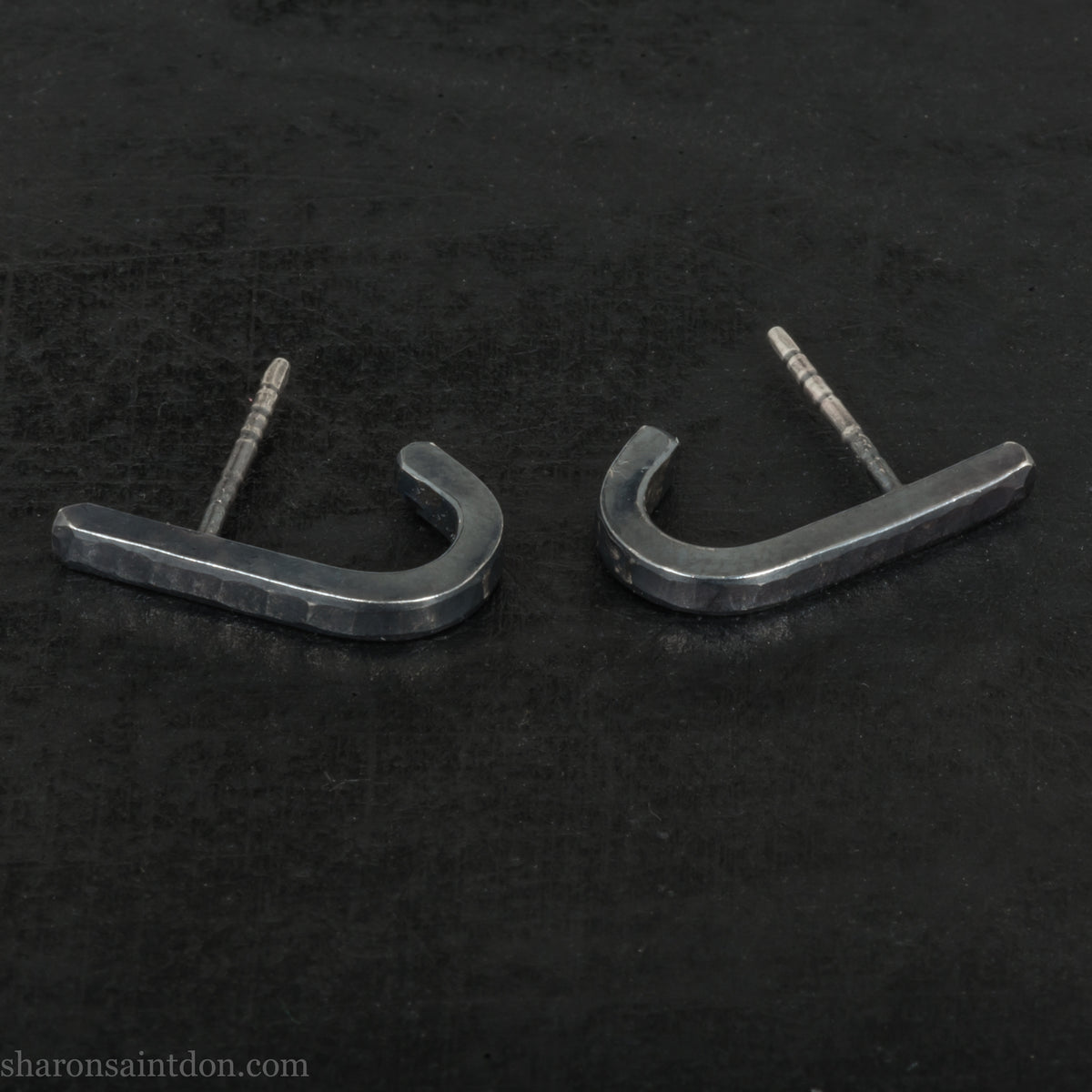 Hand hammered oxidized black sterling silver J-Curve hoop earrings, oxidized black patina.