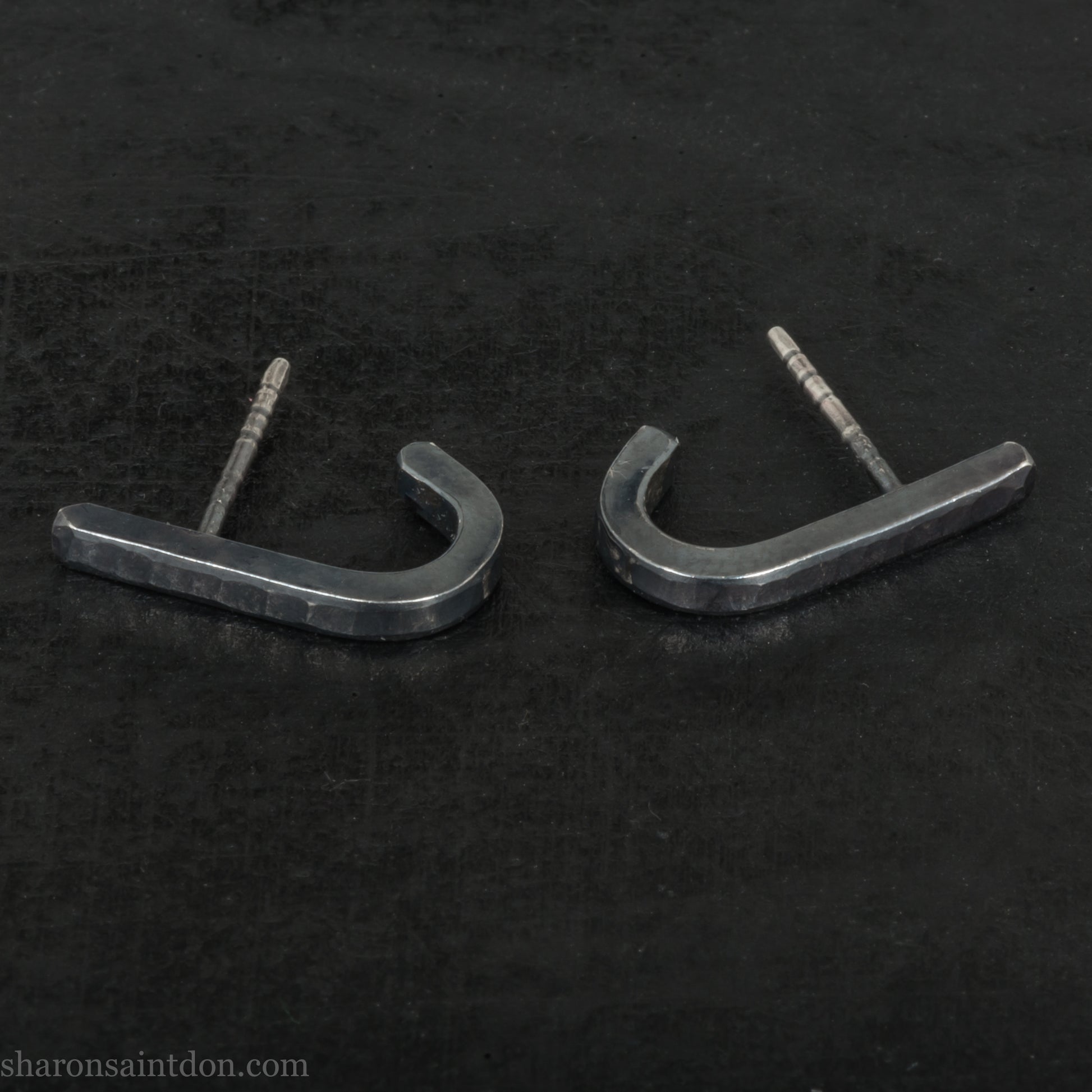 Hand hammered oxidized black sterling silver J-Curve hoop earrings, oxidized black patina.