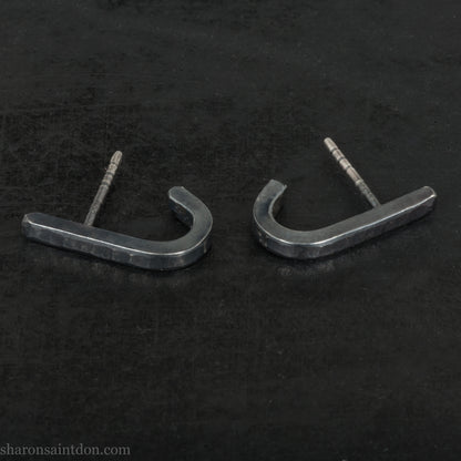 Hand hammered oxidized black sterling silver J-Curve hoop earrings, oxidized black patina.