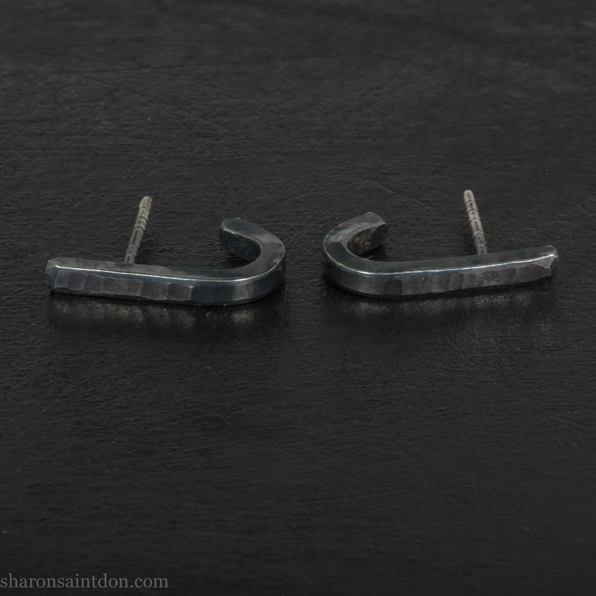 Hand hammered oxidized black sterling silver J-Curve hoop earrings, oxidized black patina.