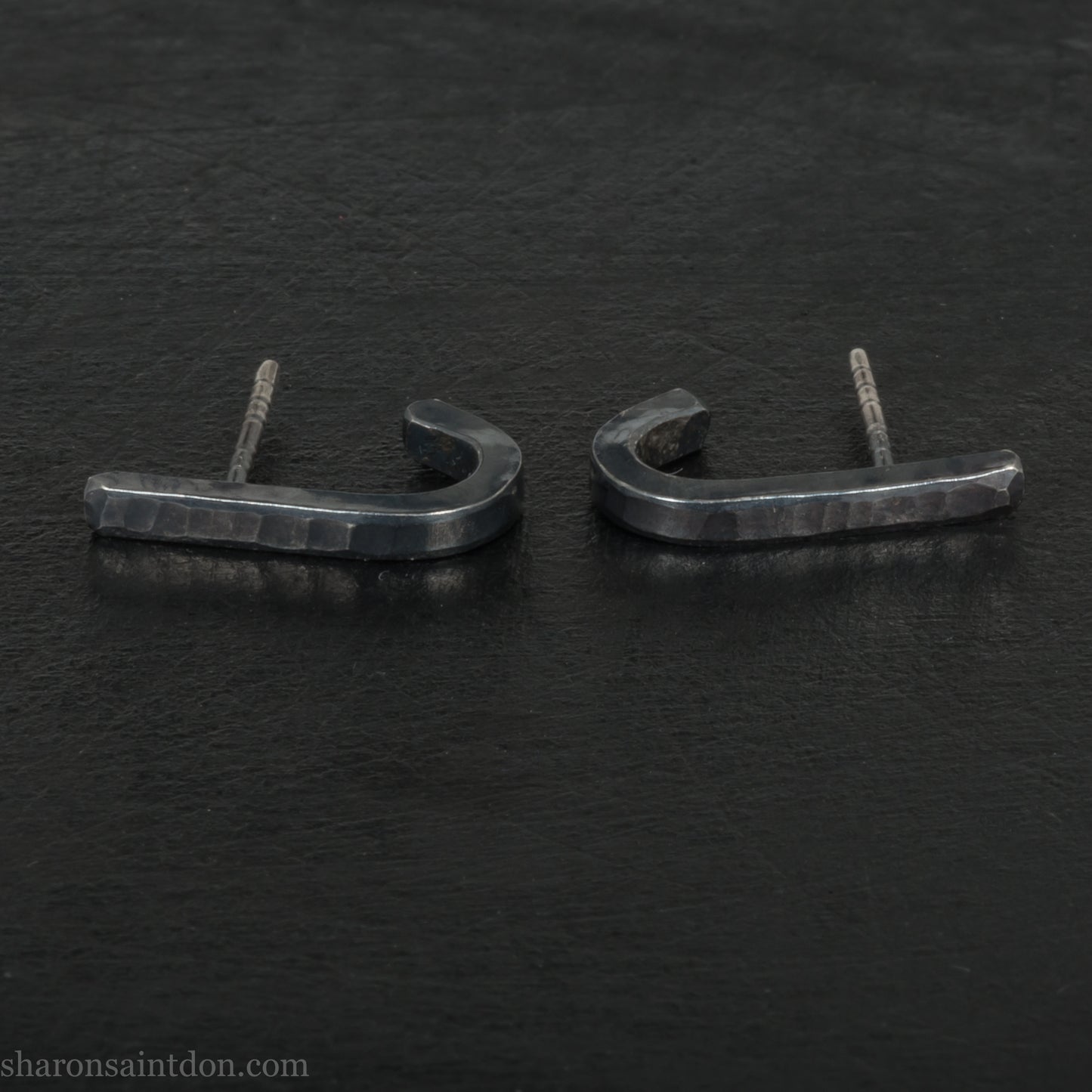 Hand hammered oxidized black sterling silver J-Curve hoop earrings, oxidized black patina.