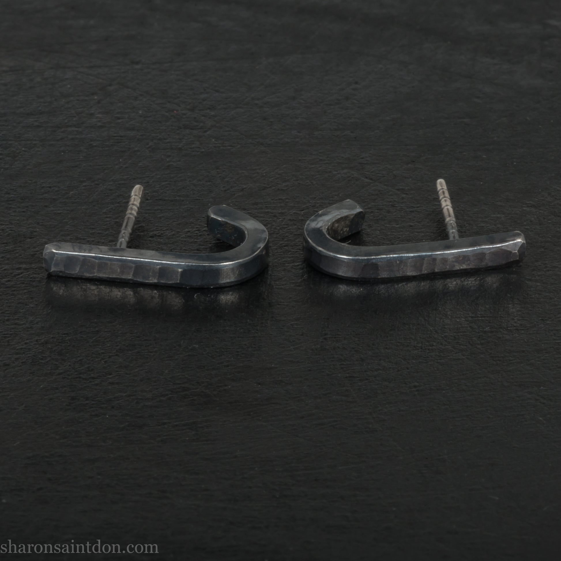 Hand hammered oxidized black sterling silver J-Curve hoop earrings, oxidized black patina.