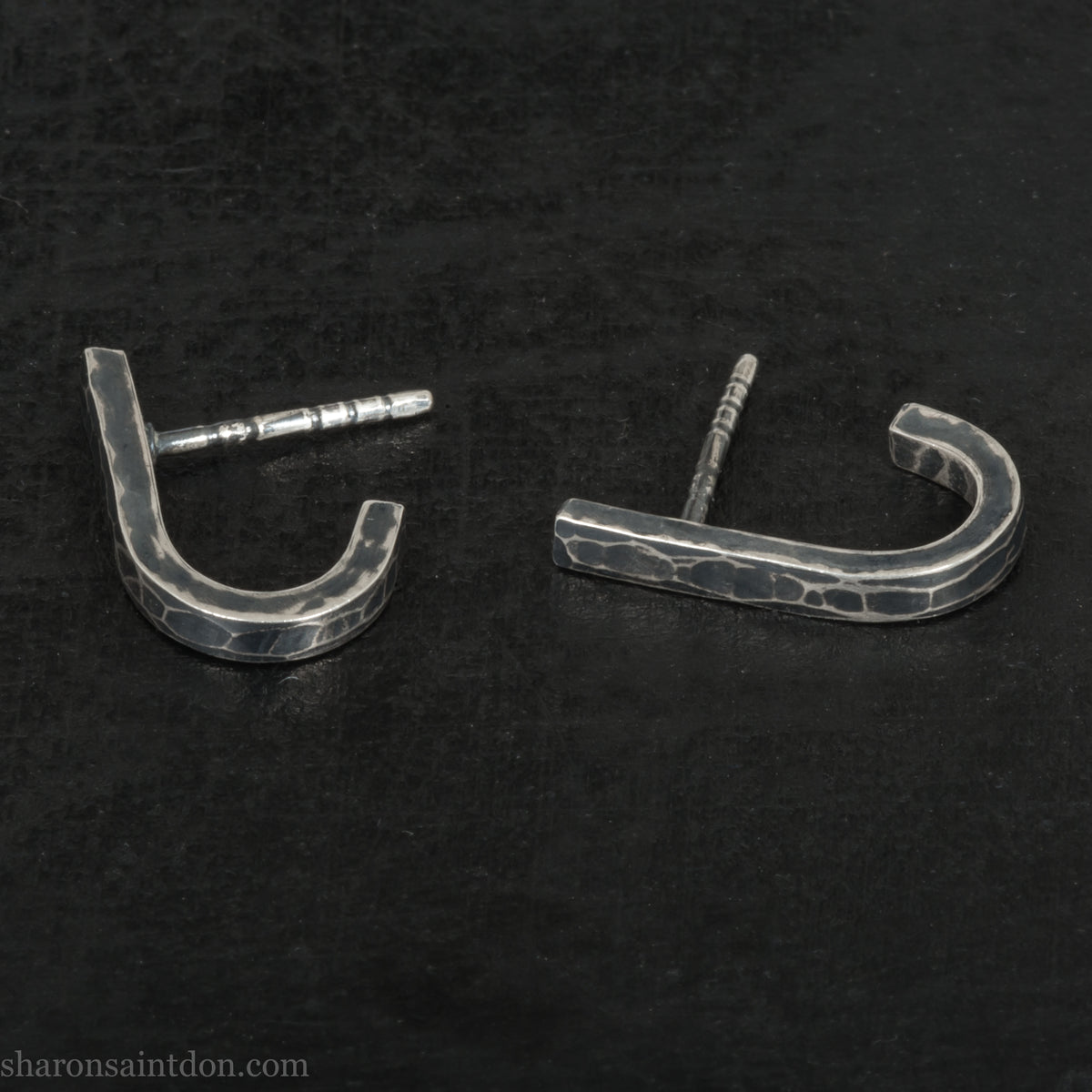 Hand hammered oxidized sterling silver J-wrap hoop earring, dark antique patina.