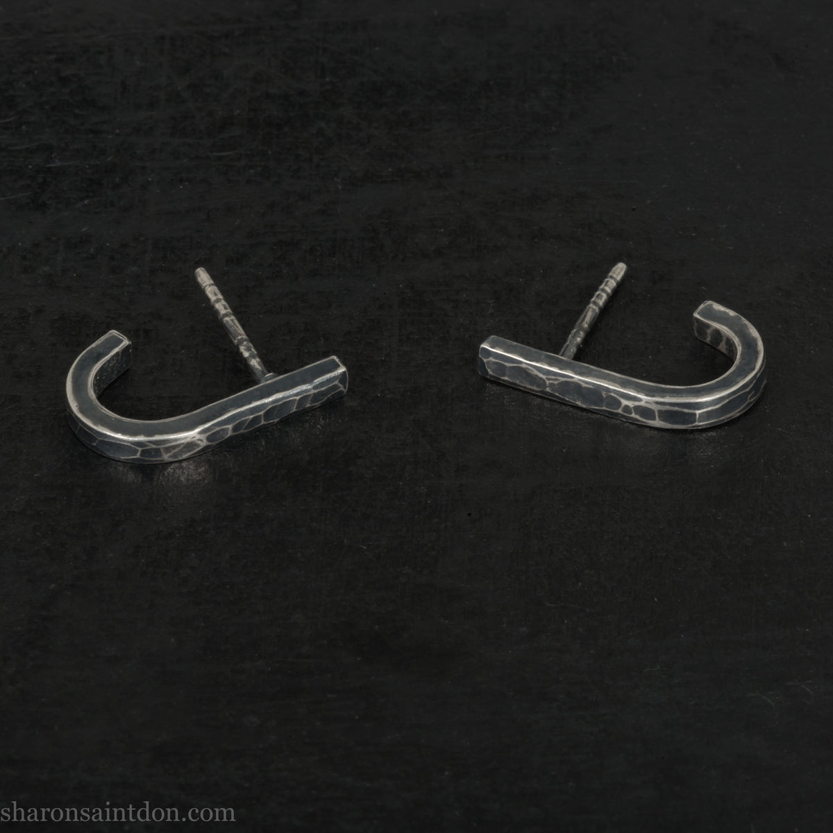 Hand hammered oxidized sterling silver J-wrap hoop earring, dark antique patina.