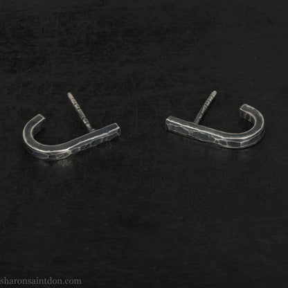 Hand hammered oxidized sterling silver J-wrap hoop earring, dark antique patina.
