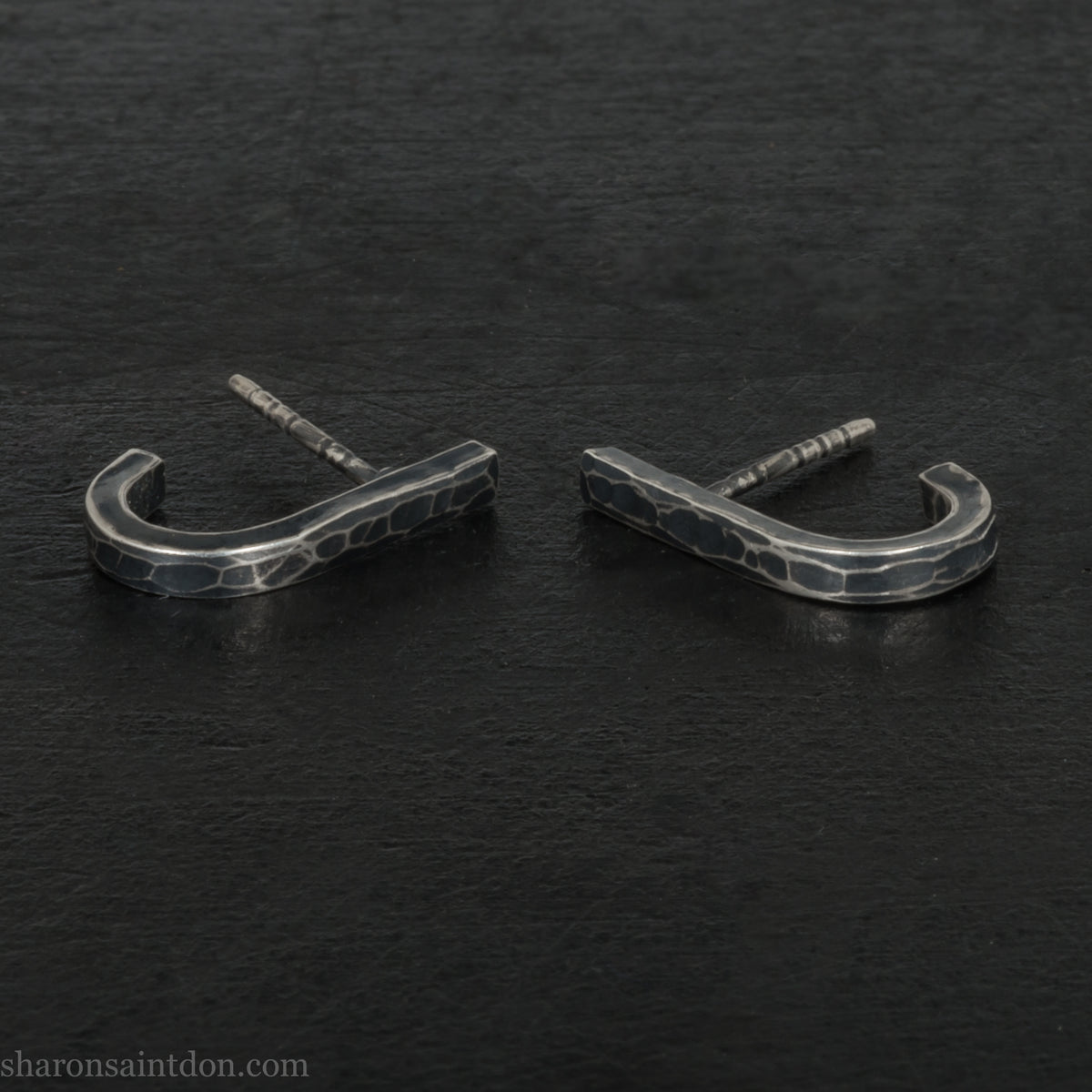 Hand hammered oxidized sterling silver J-wrap hoop earring, dark antique patina.