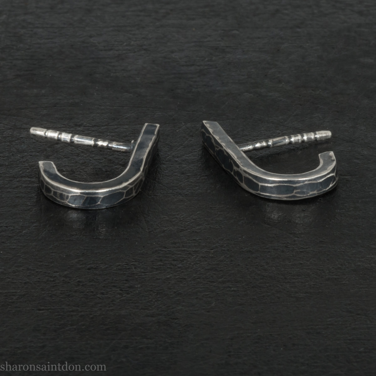 Hand hammered oxidized sterling silver J-wrap hoop earring, dark antique patina.