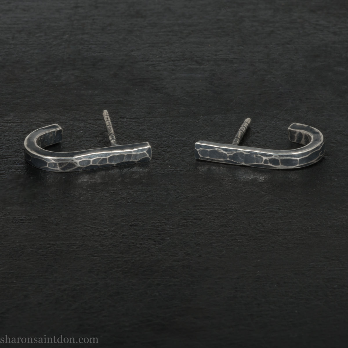 Hand hammered oxidized sterling silver J-wrap hoop earring, dark antique patina.