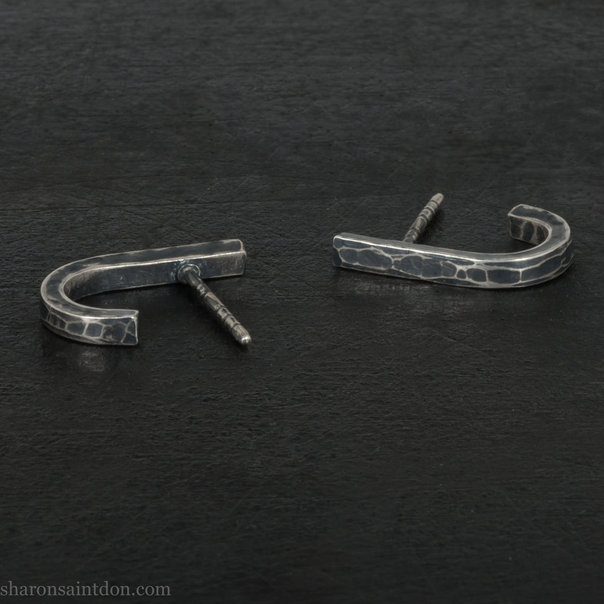 Hand hammered oxidized sterling silver J-wrap hoop earring, dark antique patina.