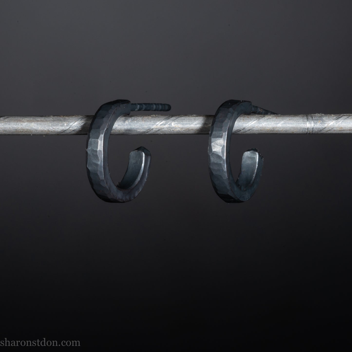 Solid 925 sterling silver hoop earrings for men with an oxidized matte black finish. 12mm exterior diameter, 9mm interior, 2mm wide, and 1.5mm thick. Solid sterling silver posts and backs. Handcrafted, each pair hand hammered by Sharon Saint Don in the Pacific Northwest of the USA.