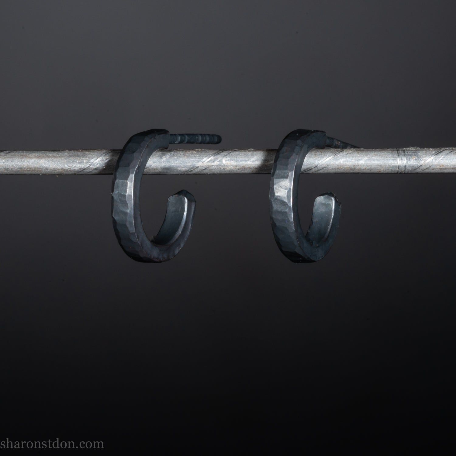 Solid 925 sterling silver hoop earrings for men with an oxidized matte black finish. 12mm exterior diameter, 9mm interior, 2mm wide, and 1.5mm thick. Solid sterling silver posts and backs. Handcrafted, each pair hand hammered by Sharon Saint Don in the Pacific Northwest of the USA.