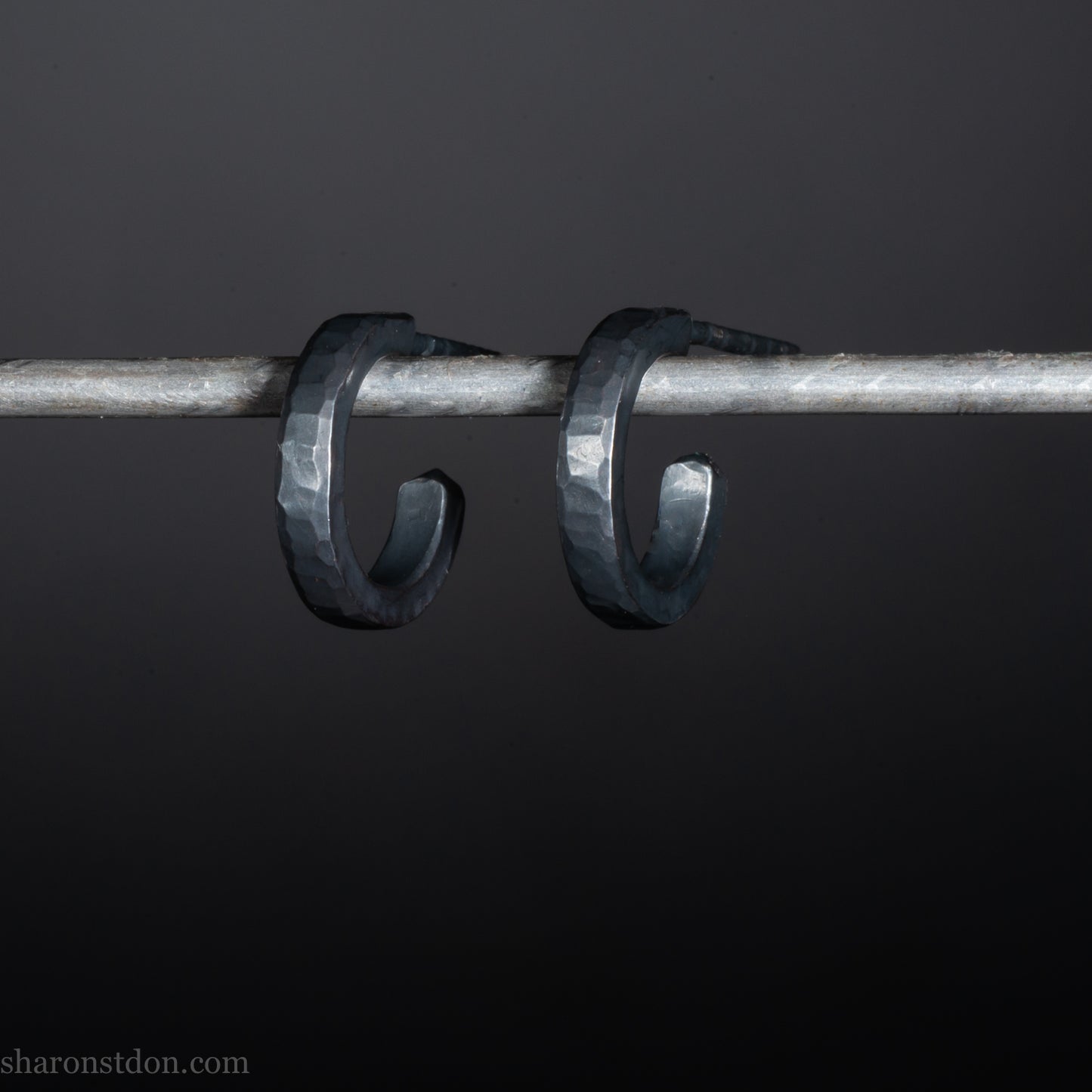 Solid 925 sterling silver hoop earrings for men with an oxidized matte black finish. 12mm exterior diameter, 9mm interior, 2mm wide, and 1.5mm thick. Solid sterling silver posts and backs. Handcrafted, each pair hand hammered by Sharon Saint Don in the Pacific Northwest of the USA.
