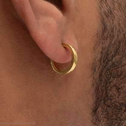 18k yellow gold hammered hoop earring, 14mm diameter, matte brushed finish, worn on ear.
