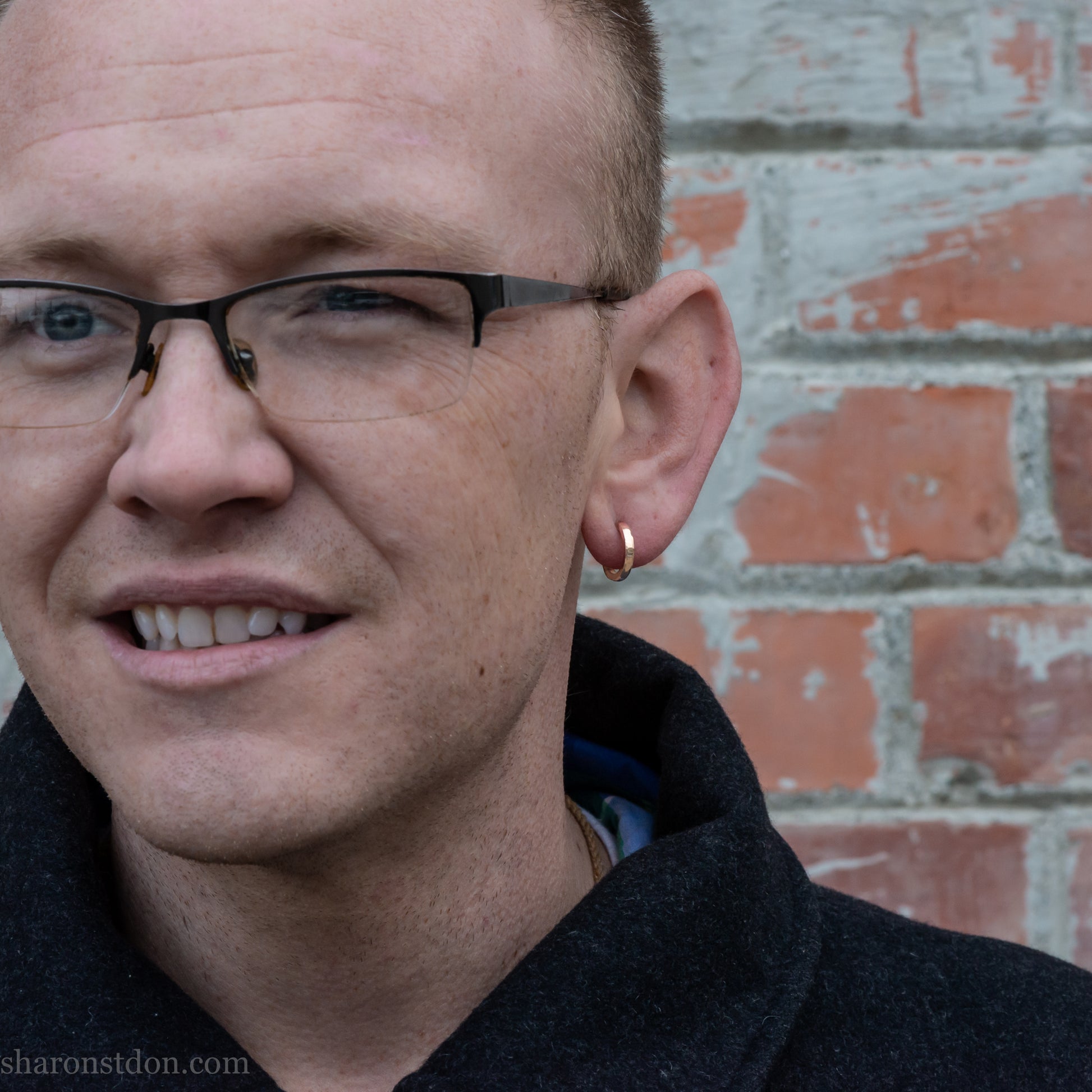 14k yellow gold hammered hoop earring, 14mm diameter, matte brushed finish, worn on ear.