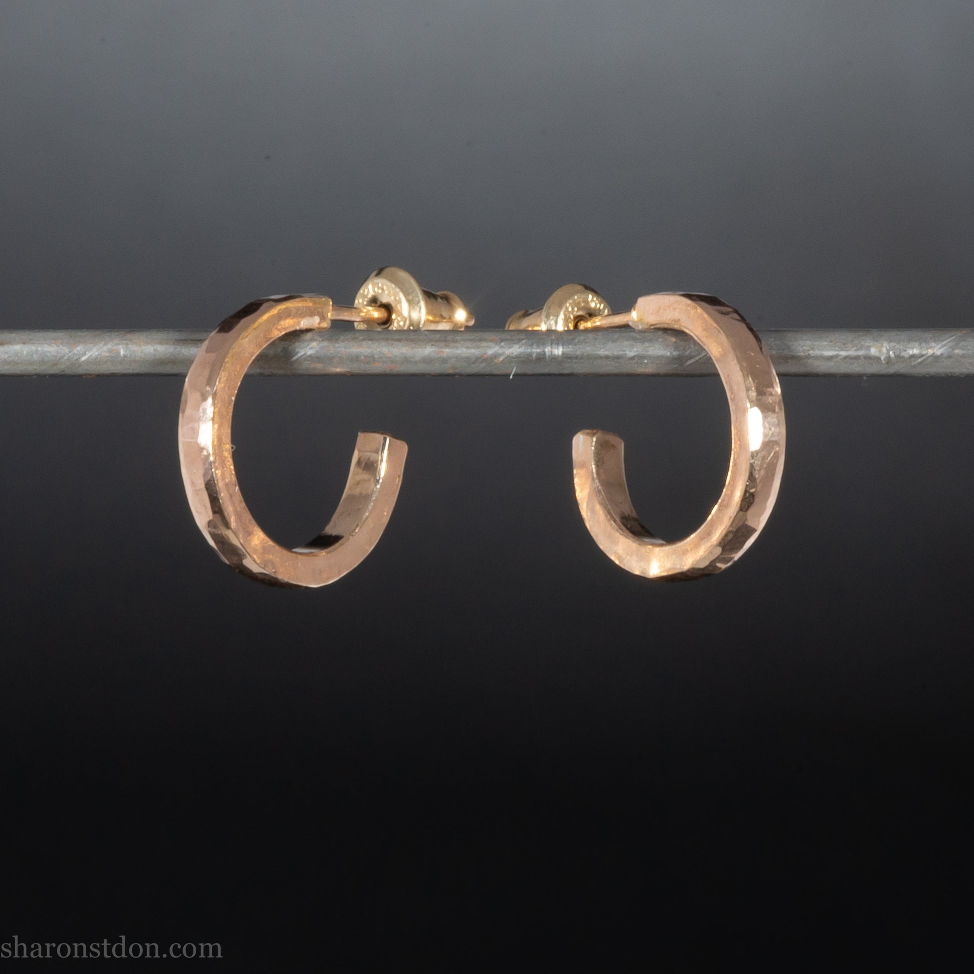 14k yellow gold hammered hoop earring, 14mm diameter, matte brushed finish, worn on ear.