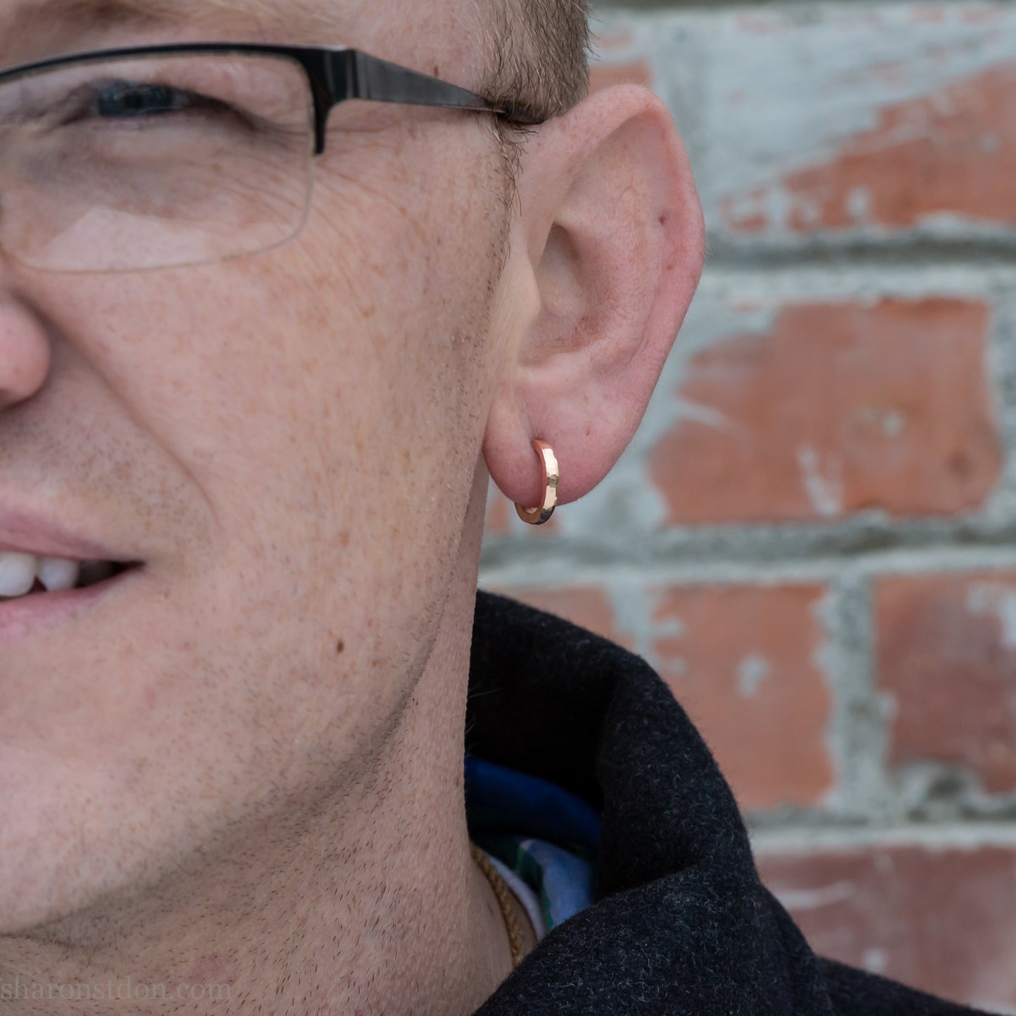 14k yellow gold hammered hoop earring, 14mm diameter, matte brushed finish, worn on ear.