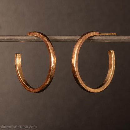 20mm solid yellow gold hoop earrings with hammered matte finish and solid gold posts, handmade by Sharon SaintDon