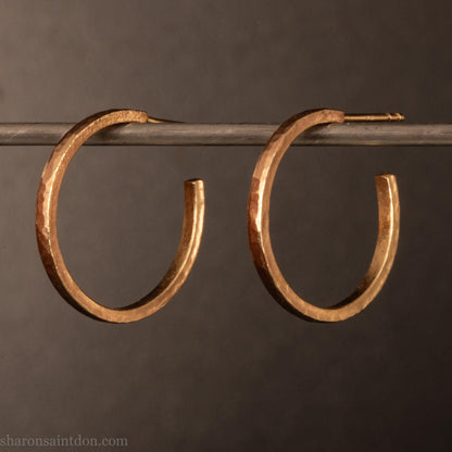 20mm solid yellow gold hoop earrings with hammered matte finish and solid gold posts, handmade by Sharon SaintDon