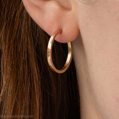 20mm solid yellow gold hoop earrings with hammered matte finish and solid gold posts, handmade by Sharon SaintDon