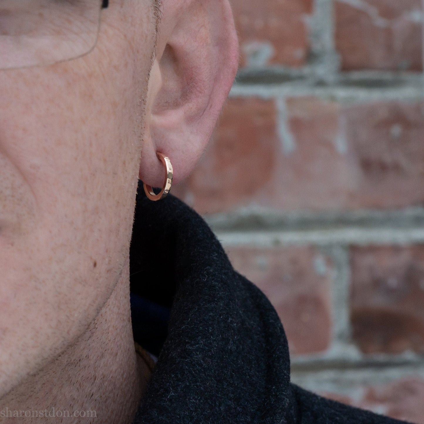 16mm solid gold hoop earrings worn on ear, handcrafted hammered finish 18k/22k yellow gold