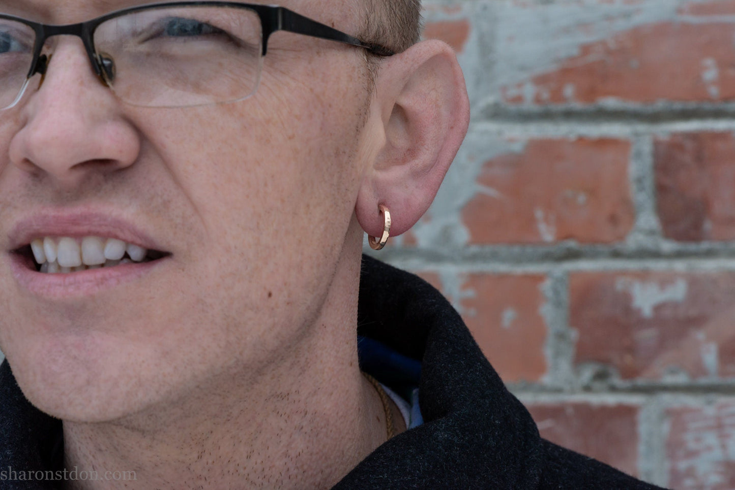 16mm solid gold hoop earrings worn on ear, handcrafted hammered finish 18k/22k yellow gold