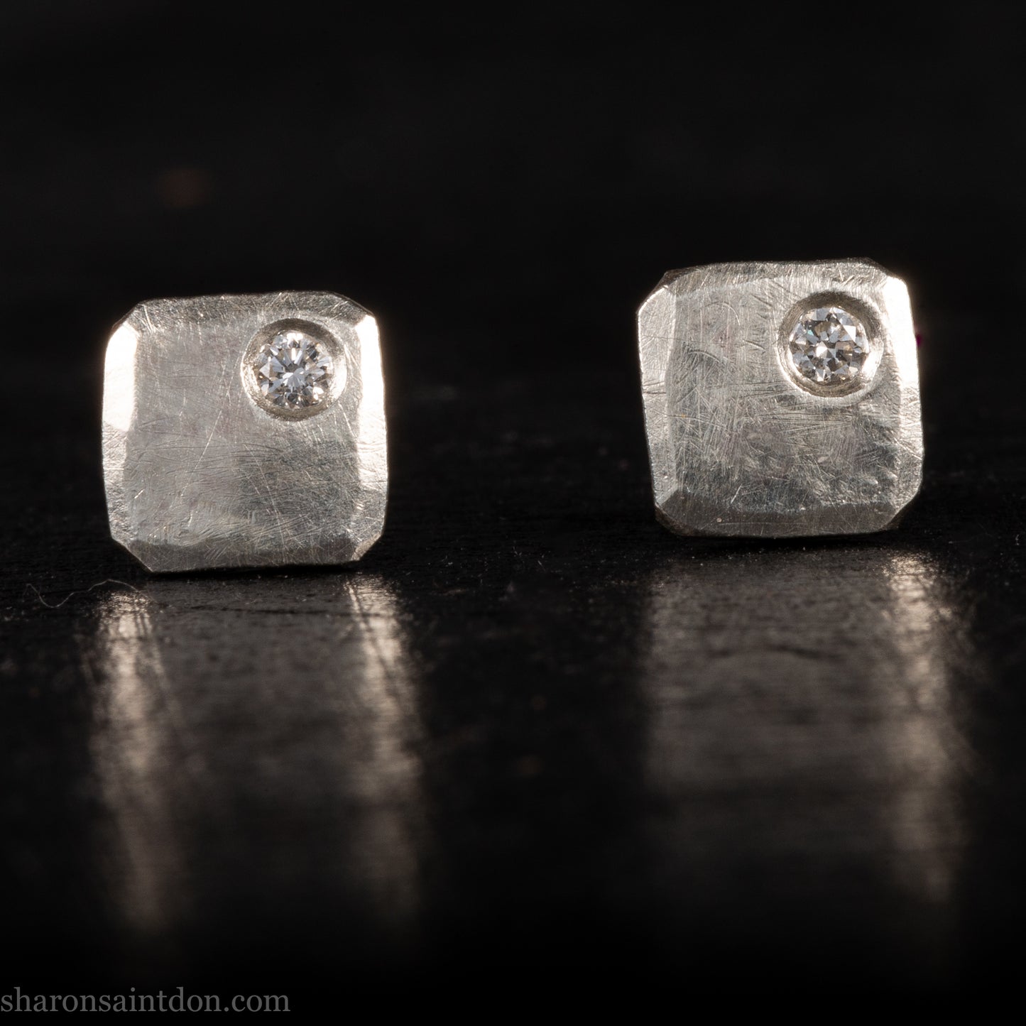 Solid 925 sterling silver stud earrings with lab-grown moissanite, 7mm square, hammered silver with brushed matte finish, corner-set stone, sterling silver posts and backs.