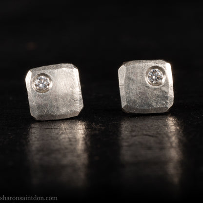 Solid 925 sterling silver stud earrings with lab-grown moissanite, 7mm square, hammered silver with brushed matte finish, corner-set stone, sterling silver posts and backs.