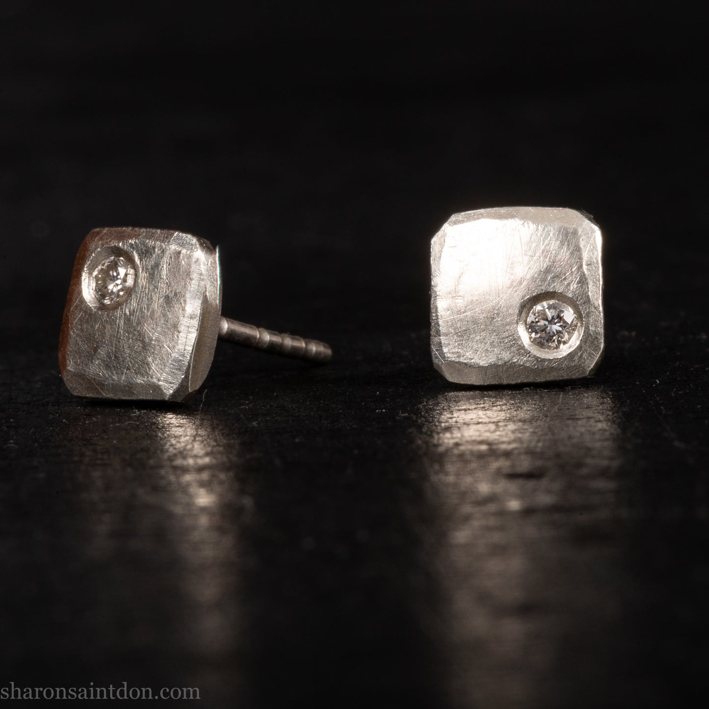 Solid 925 sterling silver stud earrings with lab-grown moissanite, 7mm square, hammered silver with brushed matte finish, corner-set stone, sterling silver posts and backs.
