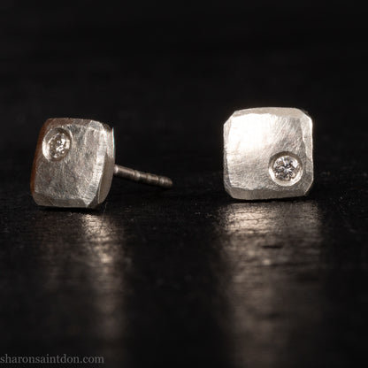 Solid 925 sterling silver stud earrings with lab-grown moissanite, 7mm square, hammered silver with brushed matte finish, corner-set stone, sterling silver posts and backs.