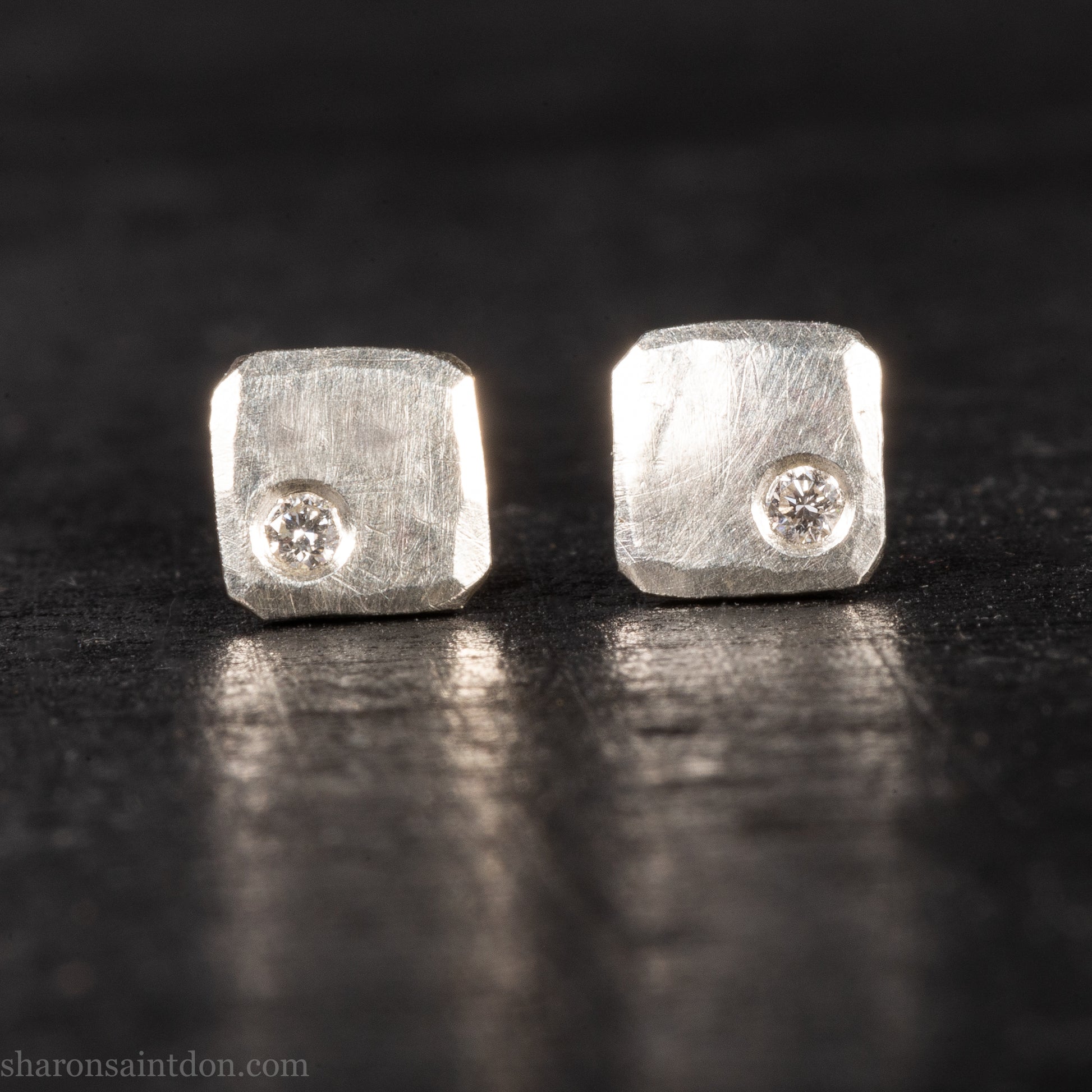 Solid 925 sterling silver stud earrings with lab-grown moissanite, 7mm square, hammered silver with brushed matte finish, corner-set stone, sterling silver posts and backs.