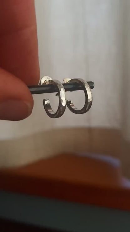 14mm x 2mm small sterling silver hoop earrings, Handmade in North America by Sharon SaintDon. Hammered solid silver with silver posts and backs and a matte, brushed finish.