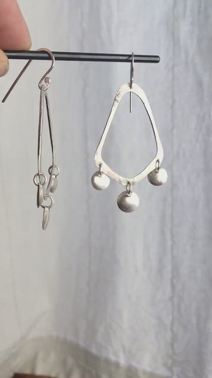 925 sterling silver handcrafted earrings. A hammered, angular, teardrop loop with three dots hanging from the angled teardrop points. Size: 60mm high to top of hook x 35mm at widest point, dots approximately 1cm. Comfortable, lightweight, with handmade ear wire hooks.