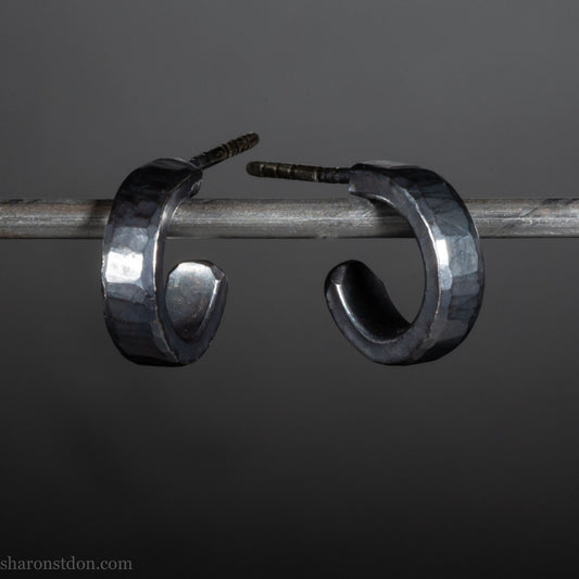 Hammered solid 925 silver hoop earrings with an oxidized black finish. 12mm exterior diameter, 9mm interior, 3mm wide. and 1.5mm thick. Solid sterling silver posts and backs. Handcrafted by Sharon Saint Don in the USA.