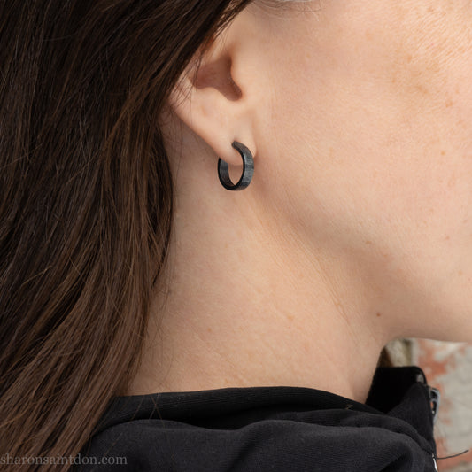 18mm x 4mm small sterling silver hoop earrings for for men or women, unisex. Handmade in North America by Sharon SaintDon. Hammered texture,solid silver with silver posts and backs  oxidized black minimalist earrings