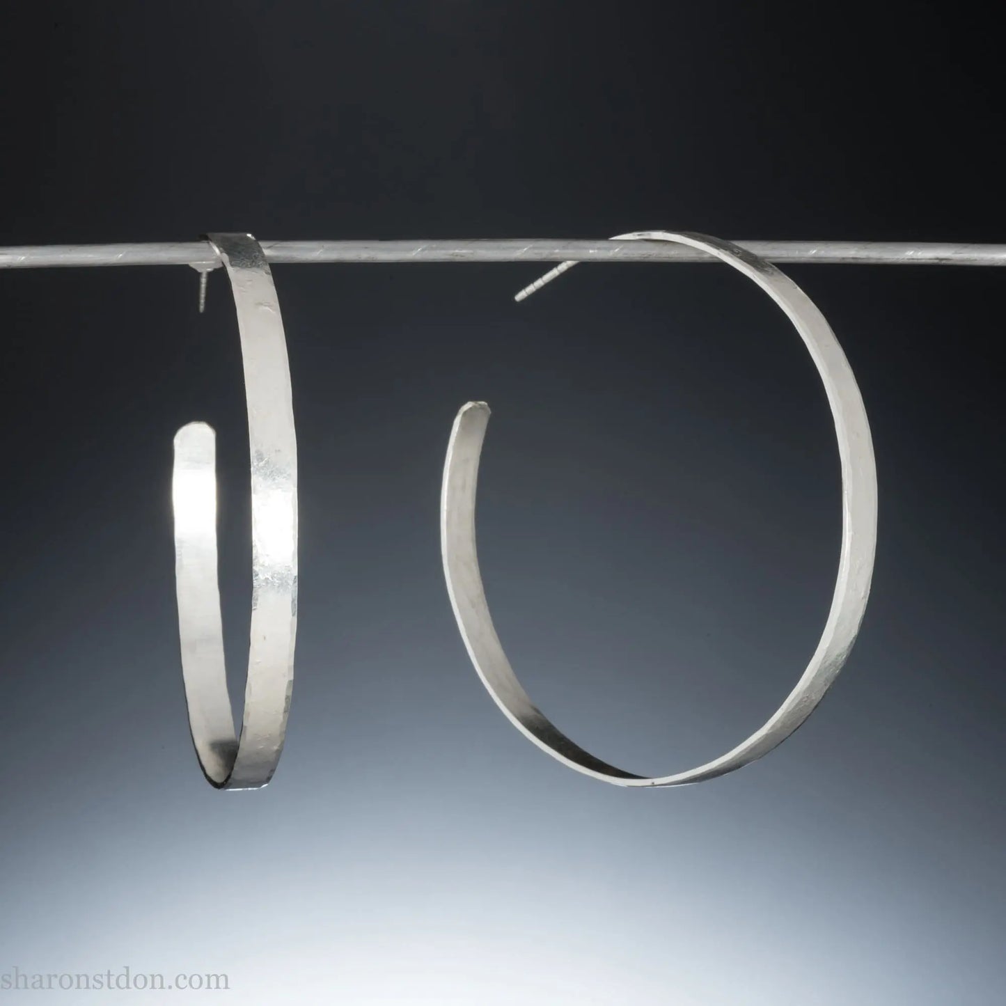 55mm sterling silver hoop earrings with hammered texture and matte brushed finish.