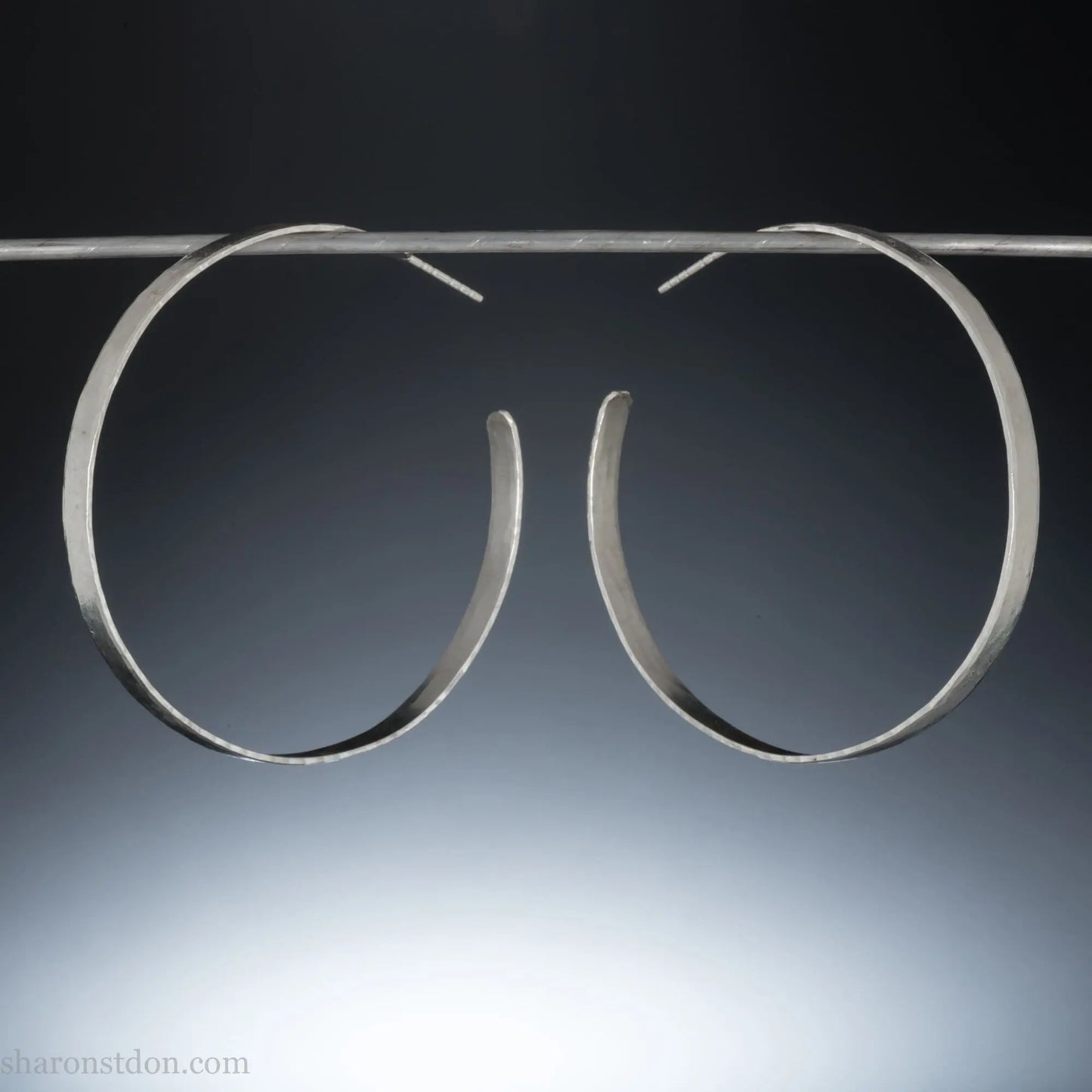 55mm sterling silver hoop earrings with hammered texture and matte brushed finish.