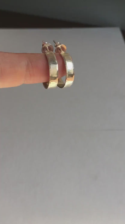 925 sterling silver hoop earrings handmade in North America by Sharon SaintDon. 18mm diameter round, 4mm wide, hammered texture, matte, brushed finish and silver posts and backs.