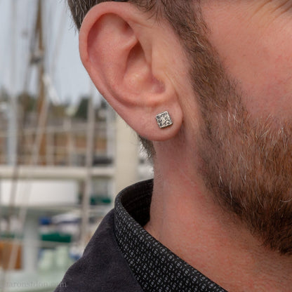 7mm square solid 925 sterling silver stud earrings, dark antique finish, on ear of man with beard.