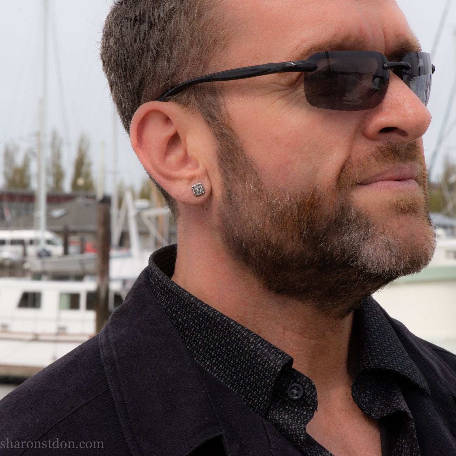 7mm square solid 925 sterling silver stud earrings, dark antique finish, on ear of man with beard.