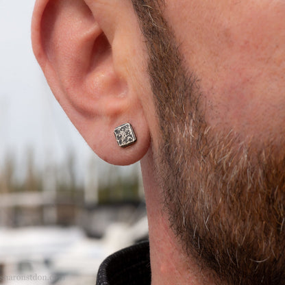 7mm square solid 925 sterling silver stud earrings, dark antique finish, on ear of man with beard.