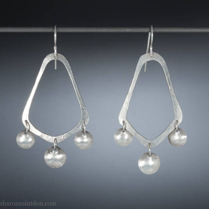 925 sterling silver handcrafted earrings. A hammered, angular, teardrop loop with three dots hanging from the angled teardrop points. Size: 60mm high to top of hook x 35mm at widest point, dots approximately 1cm. Comfortable, lightweight, with handmade ear wire hooks.
