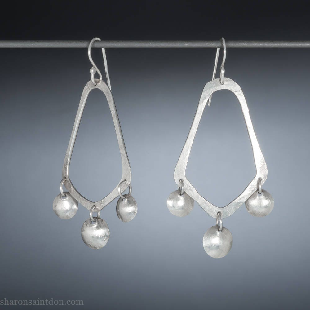 925 sterling silver handcrafted earrings. A hammered, angular, teardrop loop with three dots hanging from the angled teardrop points. Size: 60mm high to top of hook x 35mm at widest point, dots approximately 1cm. Comfortable, lightweight, with handmade ear wire hooks.