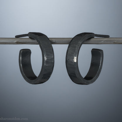18mm x 4mm small sterling silver hoop earrings for for men or women, unisex. Handmade in North America by Sharon SaintDon. Hammered texture,solid silver with silver posts and backs  oxidized black minimalist earrings
