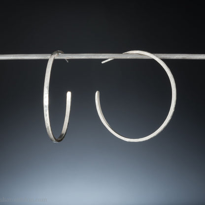 Solid 925 sterling silver hoop earrings. Handmade by Sharon SaintDon in North America. 40mm diameter, 2mm wide, 1.5mm thick, Brushed, matte finish and silver posts and backs.